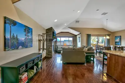 a living room with a couch and a bar at Conifer Chalet condo in South Lake Tahoe