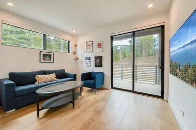 a living room with a couch and a table at Twilight Run at Palisades by Tahoe Getaways - Pet-Friendly 3BR w EV Charger & Ski Shuttle in Olympic Valley