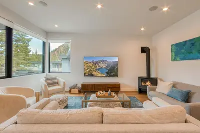 a living room with couches and a fireplace at Twilight Run at Palisades by Tahoe Getaways - Pet-Friendly 3BR w EV Charger & Ski Shuttle in Olympic Valley