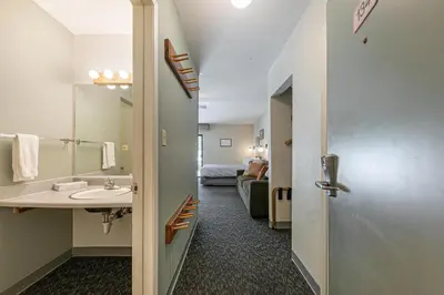 a bathroom with a sink and a room with a bed at Beautiful Studio W/Kitchenette #134 at Donner Lake Village in Truckee