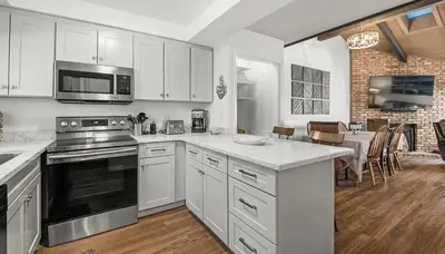 a kitchen with white cabinets and a stove top oven at Tahoe Townhome-Lake-Beach-Pool-Amenities in Incline Village