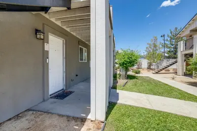 a building with a white door and a sidewalk at 3 Mi to Dtwn Gated Condo with Patio in Reno! in Reno