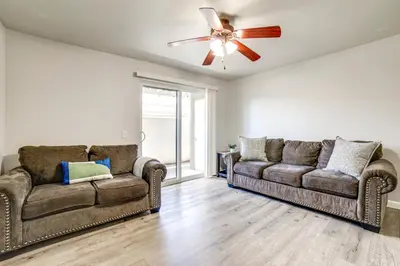 a living room with two couches and a ceiling fan at 3 Mi to Dtwn Gated Condo with Patio in Reno! in Reno