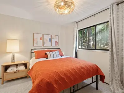 a bedroom with a bed and a window at Mountain retreat w FirePit, BBQ, Karaoke, PingPong in Arnold