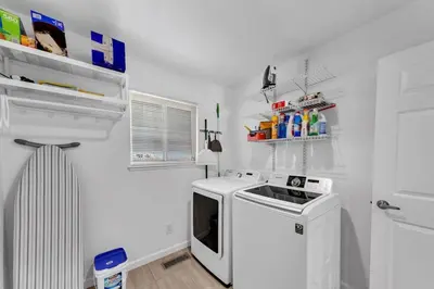 a small kitchen with a stove and a microwave at Reno Retreat-Near Downtown-UNR-Family Fun in Reno