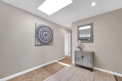 a living room with a painting on the wall at Reno Retreat-Near Downtown-UNR-Family Fun in Reno