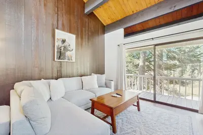 a living room with a white couch and a table at Cozy Bear Retreat in Kings Beach