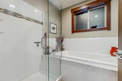 a bathroom with a tub and a glass shower at TruckeeTime in Truckee