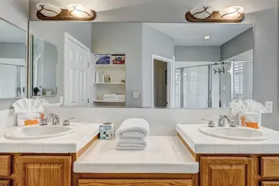 a bathroom with two sinks and a large mirror at Marina Escape-Lake-Family-Fishing-Casino in Sparks