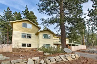 a large house with a tree in front of it at Sequoia Chalet home in Stateline