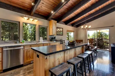 a kitchen with a large island with bar stools at Cold Creek Lodge home in South Lake Tahoe