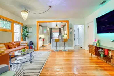 a living room with a couch and a tv at Midtown Oasis w BBQ Deck Games and Artistic Vibes in Sacramento