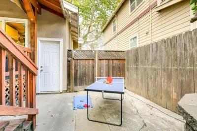 a ping pong table in the driveway of a house at Midtown Oasis w BBQ Deck Games and Artistic Vibes in Sacramento