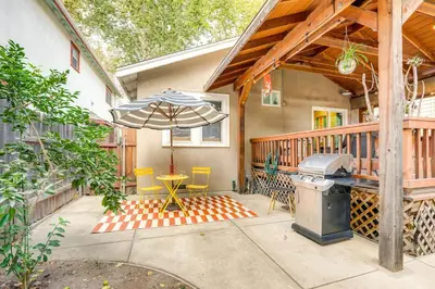 a patio with an umbrella and a table and chairs at Midtown Oasis w BBQ Deck Games and Artistic Vibes in Sacramento