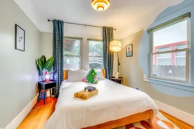 a bedroom with a bed and a window at Midtown Oasis w BBQ Deck Games and Artistic Vibes in Sacramento