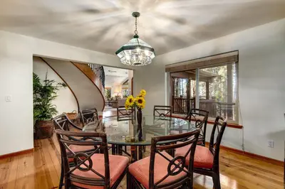 a dining room with a glass table and chairs at Silver Rock Lodge home in Zephyr Cove
