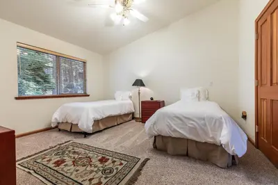 a bedroom with two beds and a window at Silver Rock Lodge home in Zephyr Cove