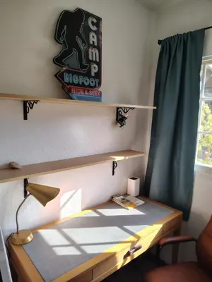 a room with a desk with a sign on the wall at Dew Drop Inn Kings Canyon National Park in Miramonte