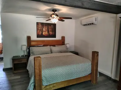 a bedroom with a bed and a ceiling fan at Dew Drop Inn Kings Canyon National Park in Miramonte