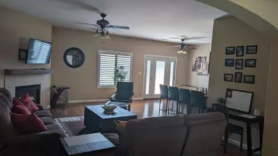 a living room with a couch and a fireplace at Tanglewood Place in Visalia
