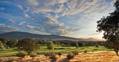 a view of a golf course with mountains in the background at Wyndham Angels Camp 3BR Apartment with Resort Access in Angels Camp