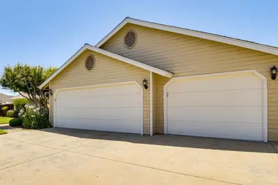a house with two garage doors in a driveway at Clovis Family Home Private Pool, Near Old Town! in Clovis