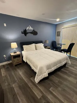 a bedroom with a large bed with a mountain on the wall at #9 Lakeside Location Beach Access View BalconyDog in Kings Beach