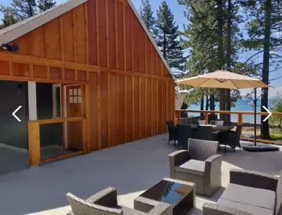 a wooden building with chairs and tables and an umbrella at #10 Lakeside Great Location Beach Access Dogs ok in Kings Beach