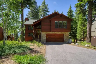 a house with a garage in front of a driveway at Wooded Escape in Tahoe Vista Private Hot Tub in Tahoe Vista