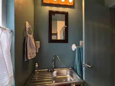 a bathroom with a sink and a mirror at 1br 1ba private ADU in Sacramento