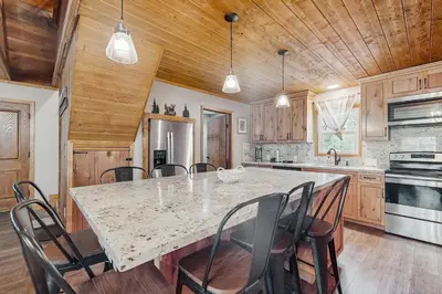 a kitchen with a table with chairs and a counter top at Little Cozy Cabin in Shaver Lake