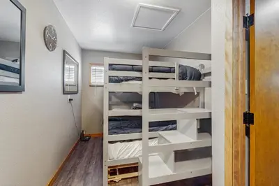 a bedroom with bunk beds in a tiny house at Little Cozy Cabin in Shaver Lake
