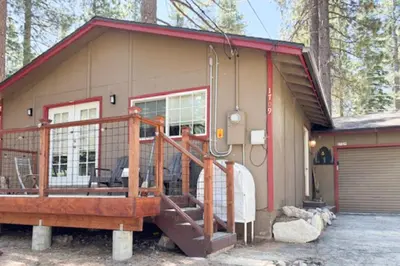 a small house with a porch and a garage at The Rikz Cabin in South Lake Tahoe