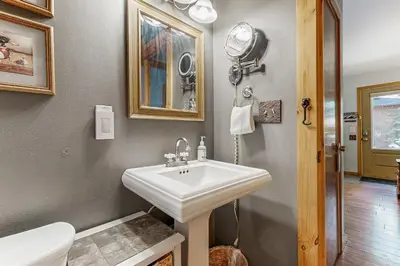 a bathroom with a white sink and a toilet at The Rikz Cabin in South Lake Tahoe
