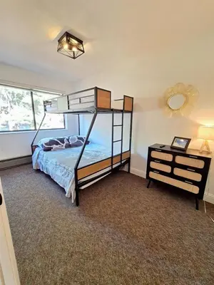 a bedroom with a bunk bed and a night stand at Tahoe Peaks & Shores Getaway in Kings Beach