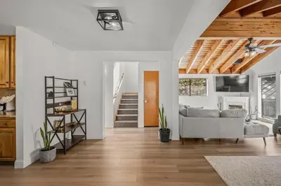 a living room with a couch and a staircase at Tahoe Peaks & Shores Getaway in Kings Beach