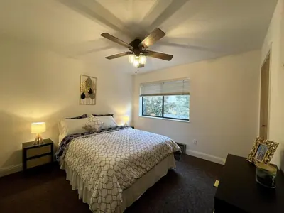 a bedroom with a bed and a ceiling fan at Tahoe Peaks & Shores Getaway in Kings Beach