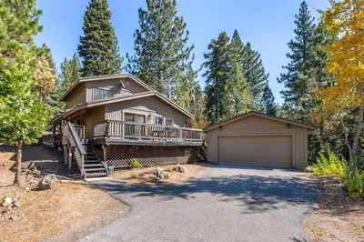 a large house with a porch and a garage at Tahoe Peaks & Shores Getaway in Kings Beach