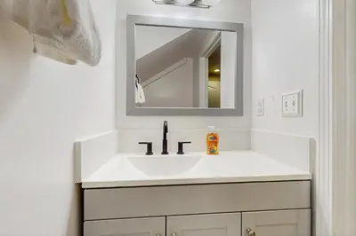 a white bathroom with a sink and a mirror at Mountain Serenity in Incline Village