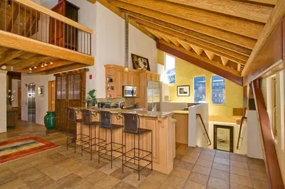 a large kitchen with bar stools and an island at Downtown Penthouse condo in South Lake Tahoe