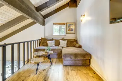 a living room with a couch and a table at Walk to Diamond Peak Luxe Chalet with Mtn-View Deck in Incline Village