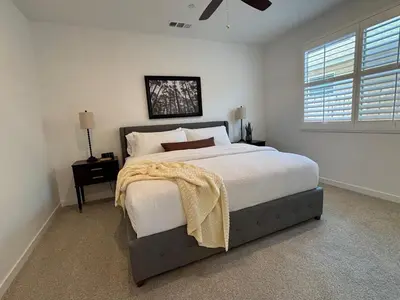a bedroom with a large bed and a window at Joyhouse in Visalia