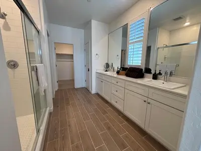 a large bathroom with two sinks and a shower at Joyhouse in Visalia
