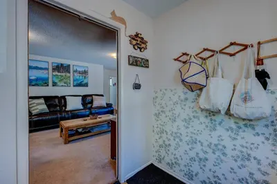 a living room with a door open to a room with a couch at Peak Summer - Relax & Refresh - Charming Kings Beach in Tahoe Vista