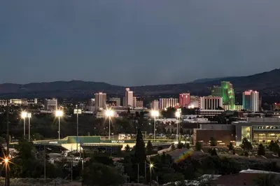 a city lit up at night with buildings at Special Rates-Skyline Escape-Reno-UNR-Tahoe in Reno