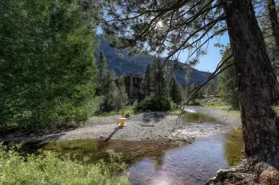 a fire hydrant on the side of a river at 1BDR Condo in the Heart of Olympic Valley! in Tahoe City