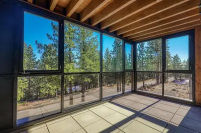 an empty living room with large windows at Crystal Bay Retreat 204 condo in Crystal Bay