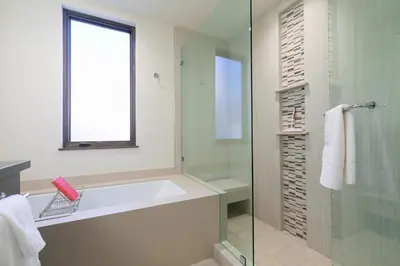 a bathroom with a tub and a glass shower at Crystal Bay Penthouse 301 condo in Crystal Bay