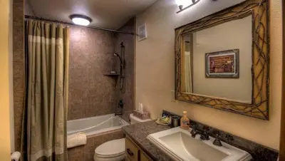 a bathroom with a sink and a tub and a toilet at Rock Haven condo in Stateline