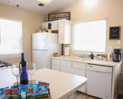 a kitchen with a white refrigerator and a counter with wine glasses at Sequoia Serenity 4 Mi to Sequoia, King Bed in Three Rivers